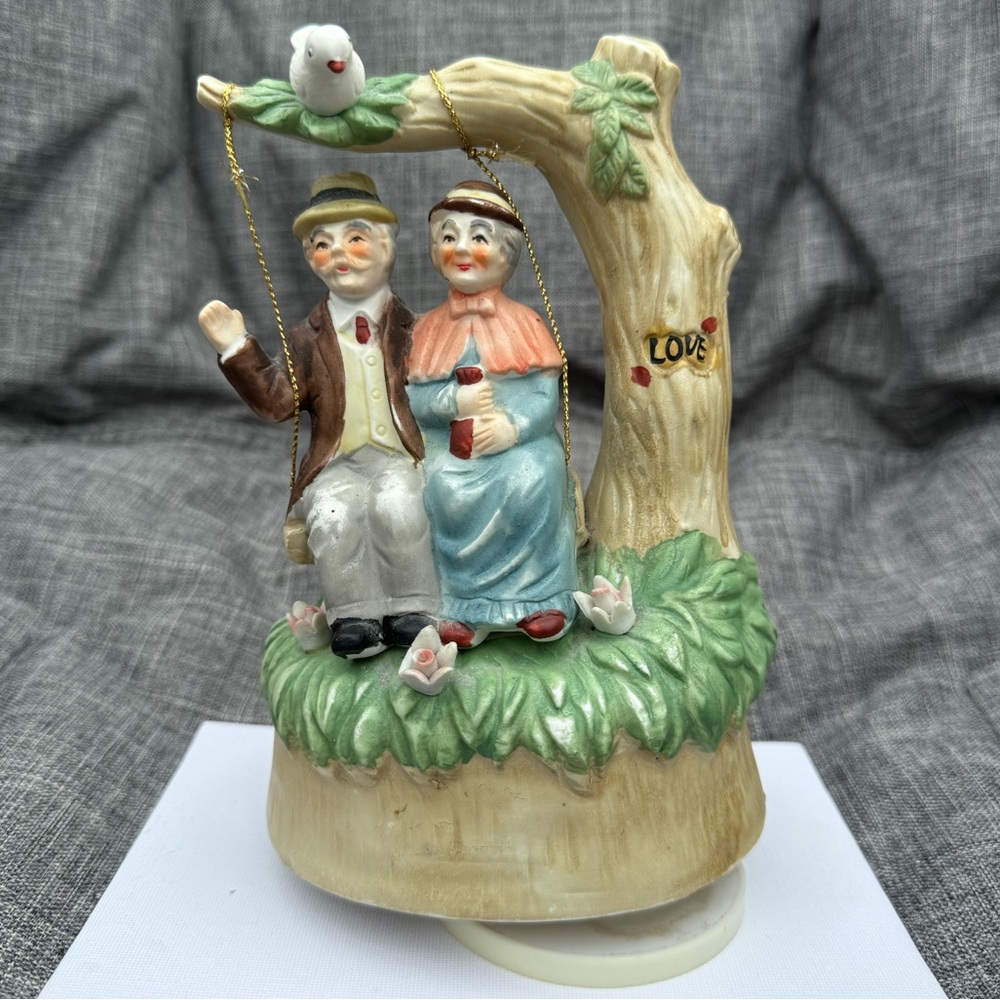 Elderly man and woman wind up music player